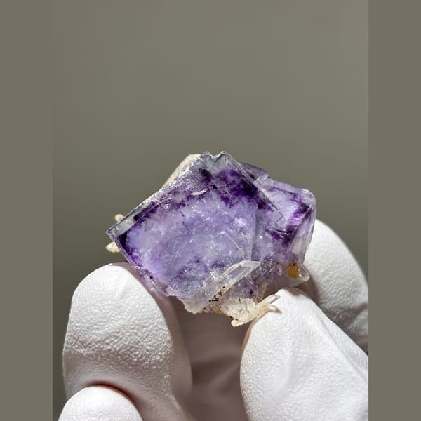 Purple fluorite cube with small quartz crystals from Yaogangxian — complete view