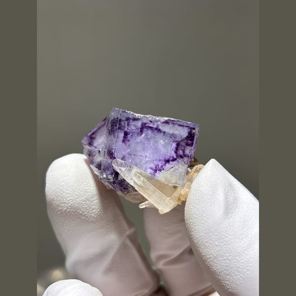 Purple fluorite cube with small quartz crystals from Yaogangxian — alternate view