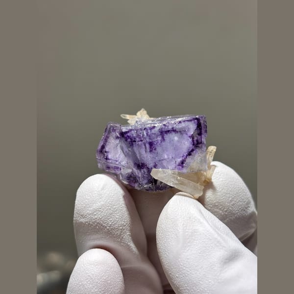 Purple fluorite cube with small quartz crystals from Yaogangxian — detail view