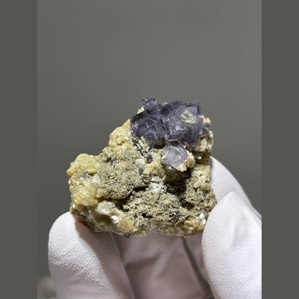 Purple fluorite cubes on mica matrix from Yaogangxian — alternate view
