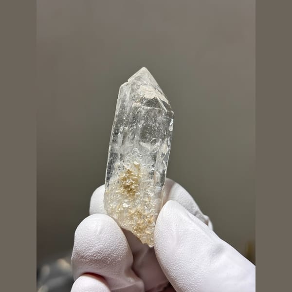 Slender clear quartz point from Xuebaoding — complete view
