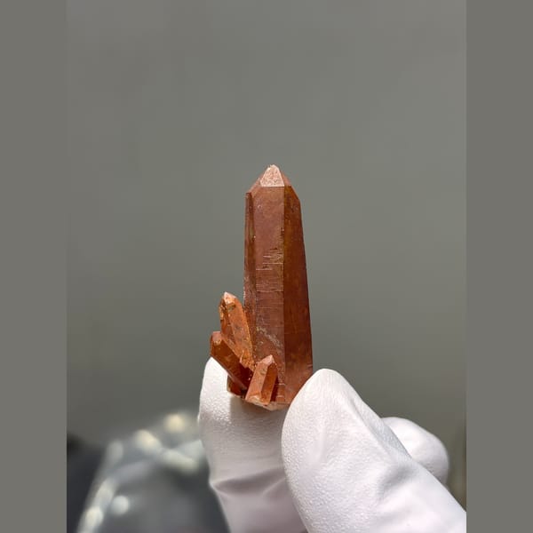 Red hematite coated quartz point from Brazil — complete view