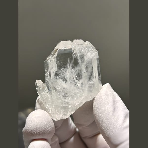 Flat clear quartz crystal from Xuebaoding — complete view