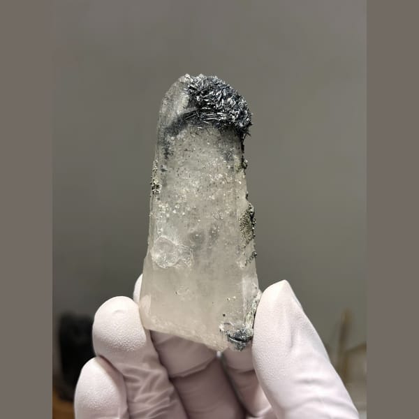Quartz crystal dusted with dark jamesonite from Hunan — complete view