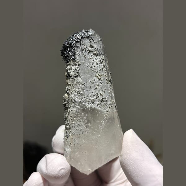 Quartz crystal dusted with dark jamesonite from Hunan — alternate view