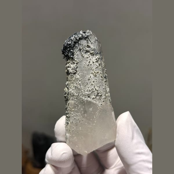 Quartz crystal dusted with dark jamesonite from Hunan — alternate view