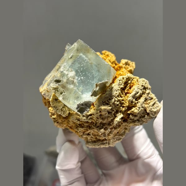 Pale green fluorite cubes on orange matrix from Yaogangxian — complete view