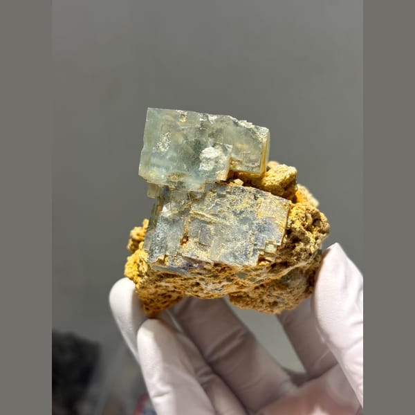 Pale green fluorite cubes on orange matrix from Yaogangxian — alternate view
