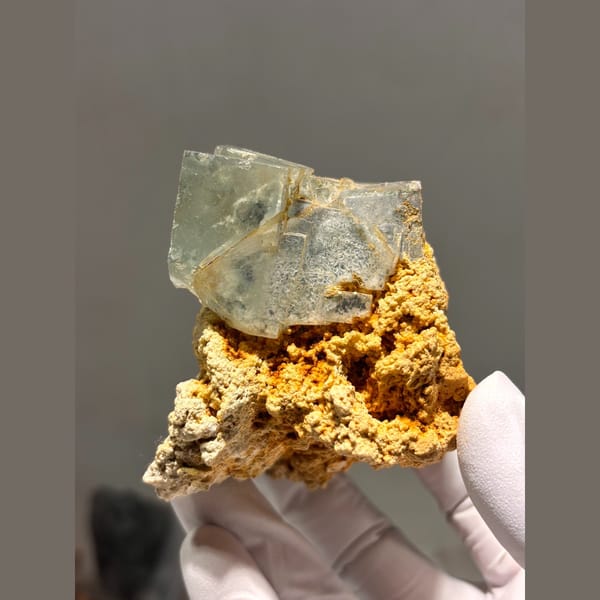 Pale green fluorite cubes on orange matrix from Yaogangxian — detail view