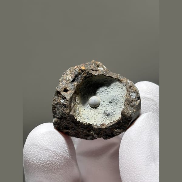 Tiny calcite pearl in a frosty matrix pocket from Zhejiang — detail view