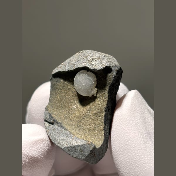 White calcite ball in grey matrix from Zhejiang — alternate view