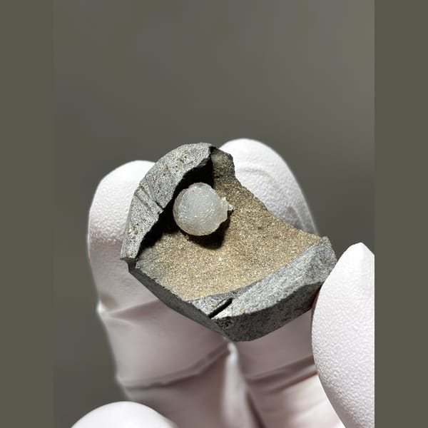 White calcite ball in grey matrix from Zhejiang — alternate view