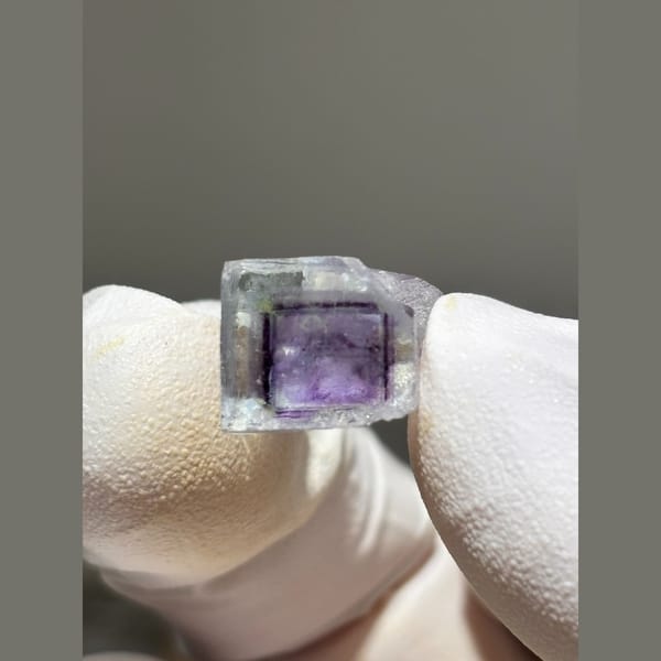 Small zoned fluorite cube with purple core from Yaogangxian — complete view