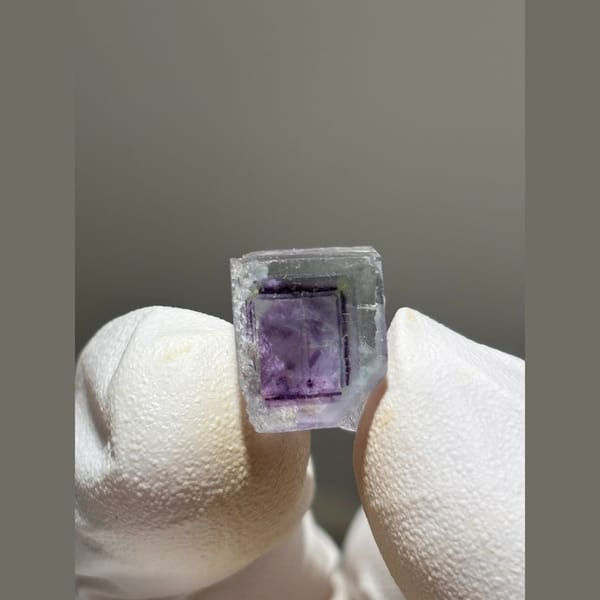 Small zoned fluorite cube with purple core from Yaogangxian — detail view