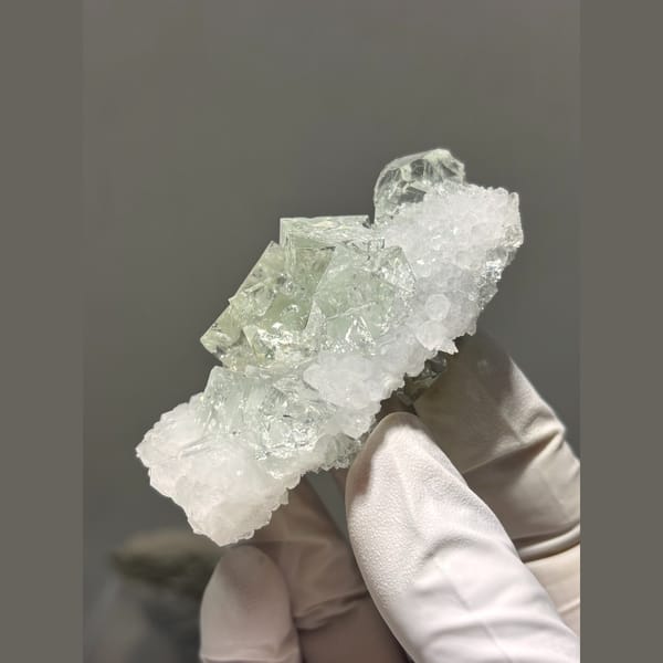 Pale green fluorite on frosty quartz plate from Zhejiang — alternate view