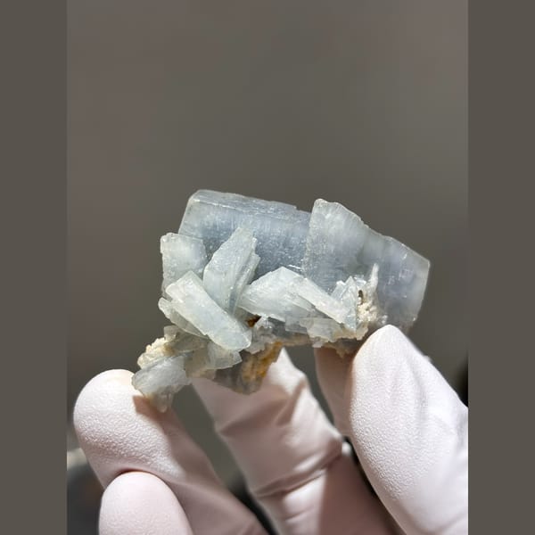 Natural pale blue bladed barite crystal cluster — complete view