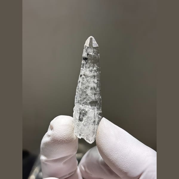 Slender double terminated clear quartz from Xuebaoding — complete view