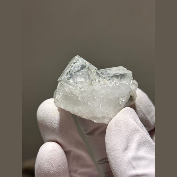 Glassy pale blue fluorite cubes on frosty quartz from Zhejiang — alternate view