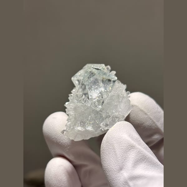 Glassy pale blue fluorite cubes on frosty quartz from Zhejiang — detail view
