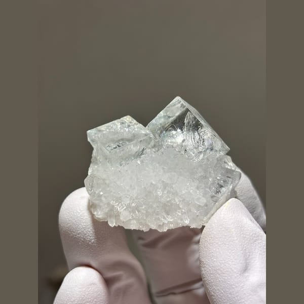 Glassy pale blue fluorite cubes on frosty quartz from Zhejiang — detail view