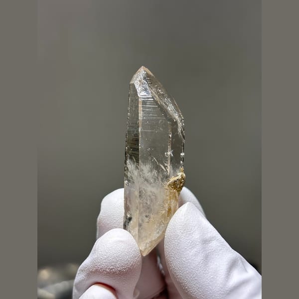 Slender clear quartz point from Xuebaoding — complete view