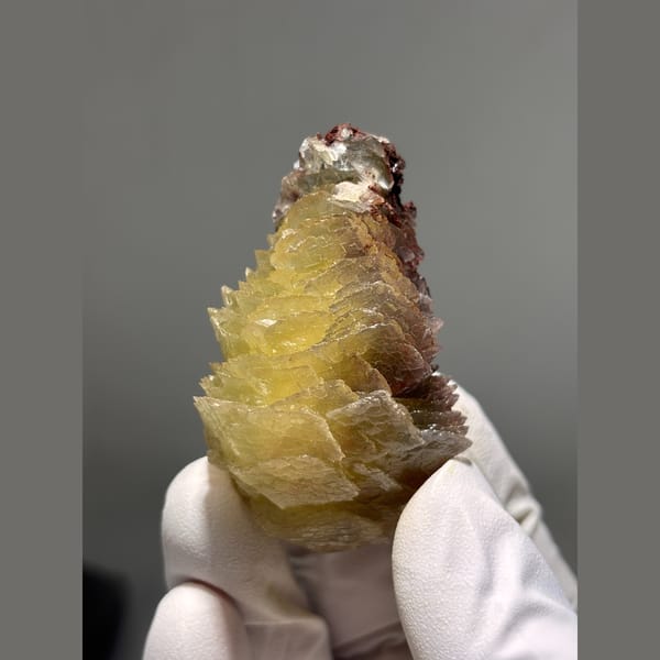 Layered honey yellow calcite on red matrix from Hubei — alternate view