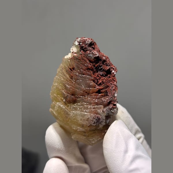 Layered honey yellow calcite on red matrix from Hubei — alternate view