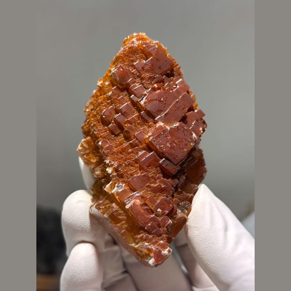 Glossy orange red calcite crystal cluster from Hubei — complete view
