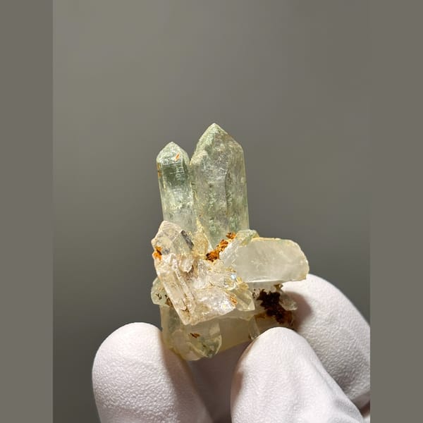 Small pale quartz cluster with rusty spots from Tibet — alternate view