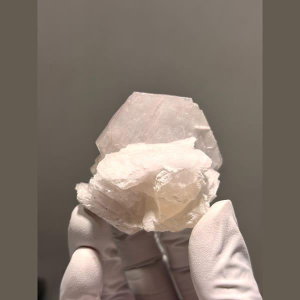 Creamy white calcite with salmon pink UV glow from Fujian — alternate view