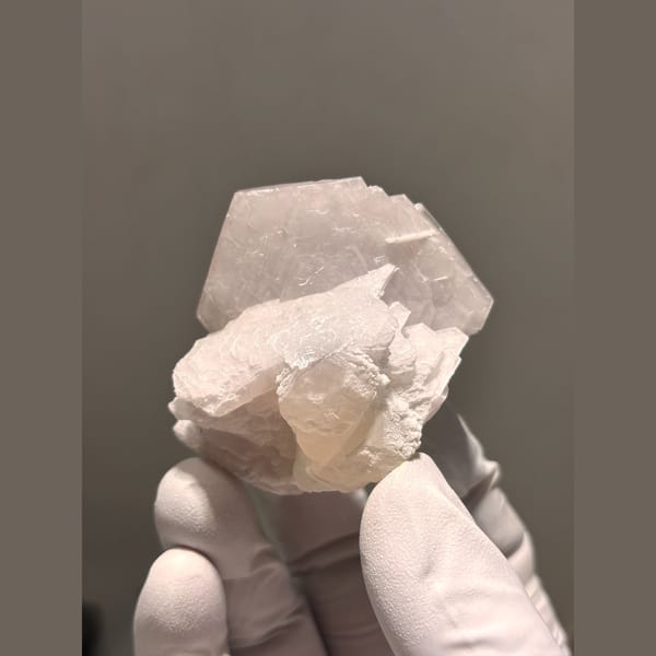 Creamy white calcite with salmon pink UV glow from Fujian — alternate view