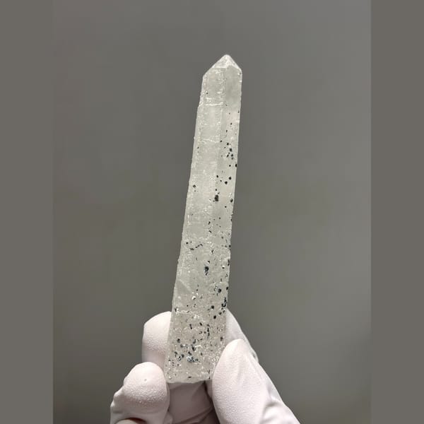 Long slender quartz with dark speck inclusions from Inner Mongolia — complete view