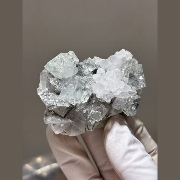 Clear stepped fluorite with quartz and calcite from Zhejiang — detail view