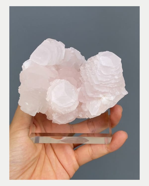 Complete normal-light front view of pale pink Hunan manganoan calcite