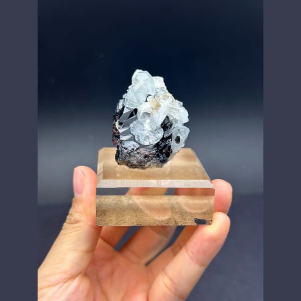 Pale blue aquamarine with black cassiterite from Xuebaoding, Sichuan — alternate view