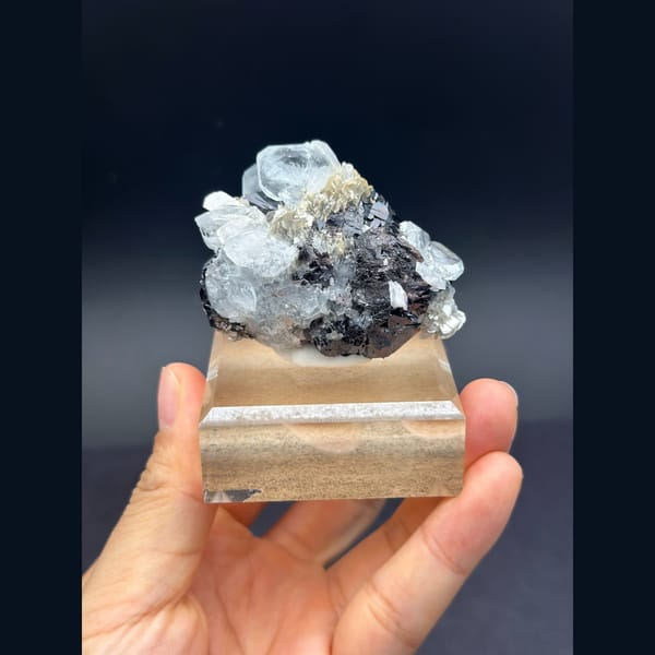 Pale blue aquamarine with black cassiterite from Xuebaoding, Sichuan — alternate view