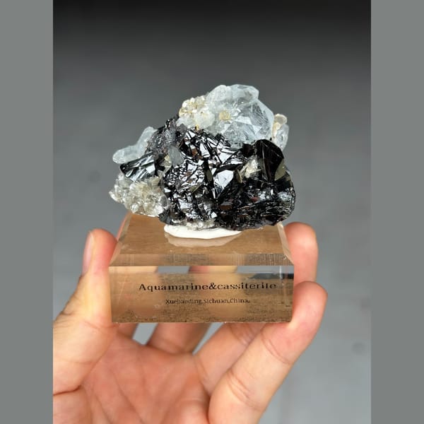 Pale blue aquamarine with black cassiterite from Xuebaoding, Sichuan — detail view