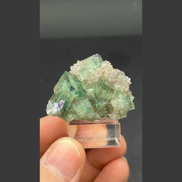Glassy transparent green fluorite cluster from Hebei — detail view