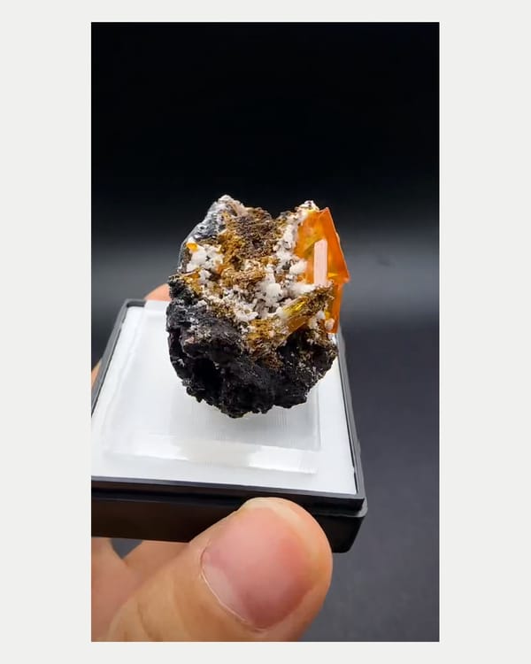 Complete right oblique view of orange wulfenite crystal cluster