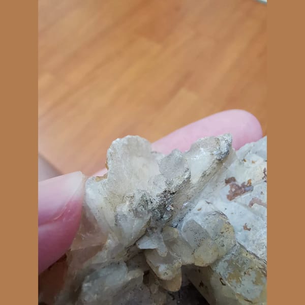 Floater calcite cluster with a quartz crystal — detail view