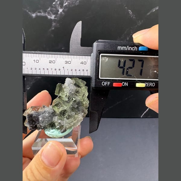 Glassy green octahedral fluorite with quartz from Fujian — detail view