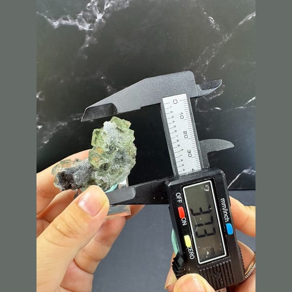 Glassy green octahedral fluorite with quartz from Fujian — detail view