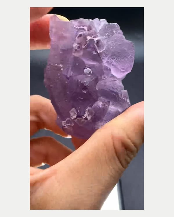 Complete left oblique view of etched purple fluorite crystal