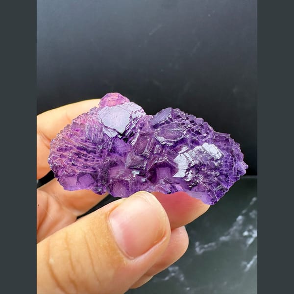 Stepped cluster of deep purple fluorite cubes from Henan — complete view