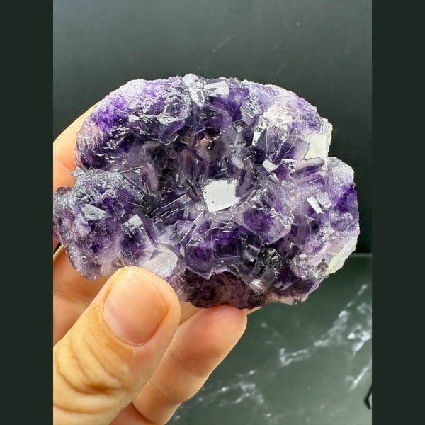 Purple and clear fluorite cluster with sparkling druse — complete view