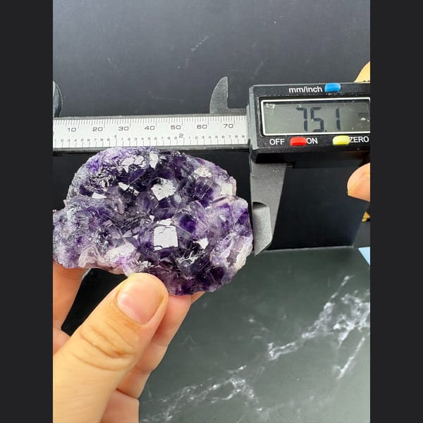 Purple and clear fluorite cluster with sparkling druse — detail view