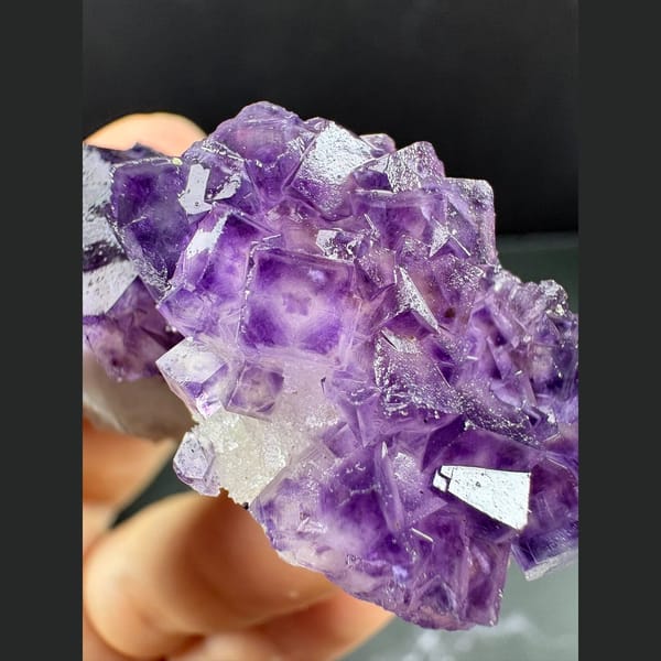 Purple fluorite with pale-windowed faces on white quartz from Henan — complete view