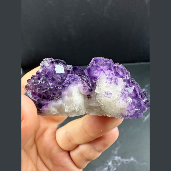 Purple fluorite with pale-windowed faces on white quartz from Henan — alternate view