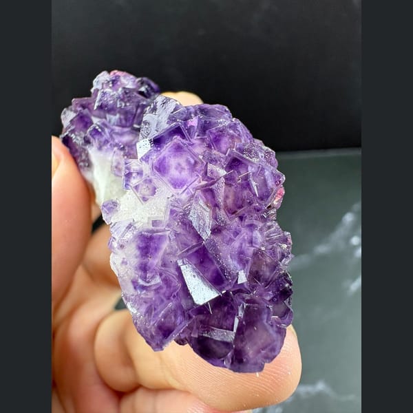 Purple fluorite with pale-windowed faces on white quartz from Henan — detail view