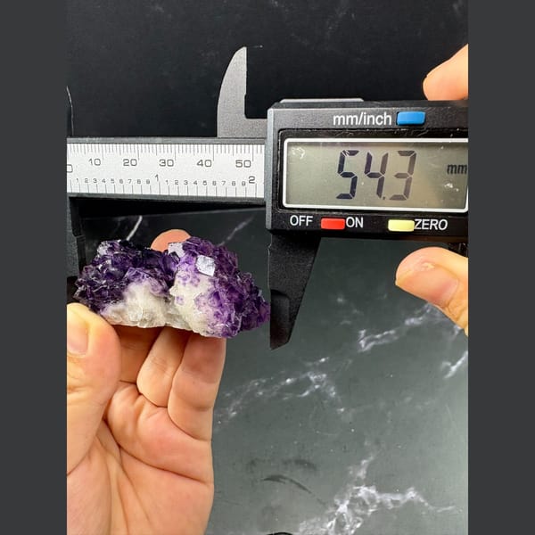 Purple fluorite with pale-windowed faces on white quartz from Henan — detail view